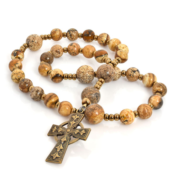 A string of Picture Jasper stone beads, with a golden cross pendant at the center.